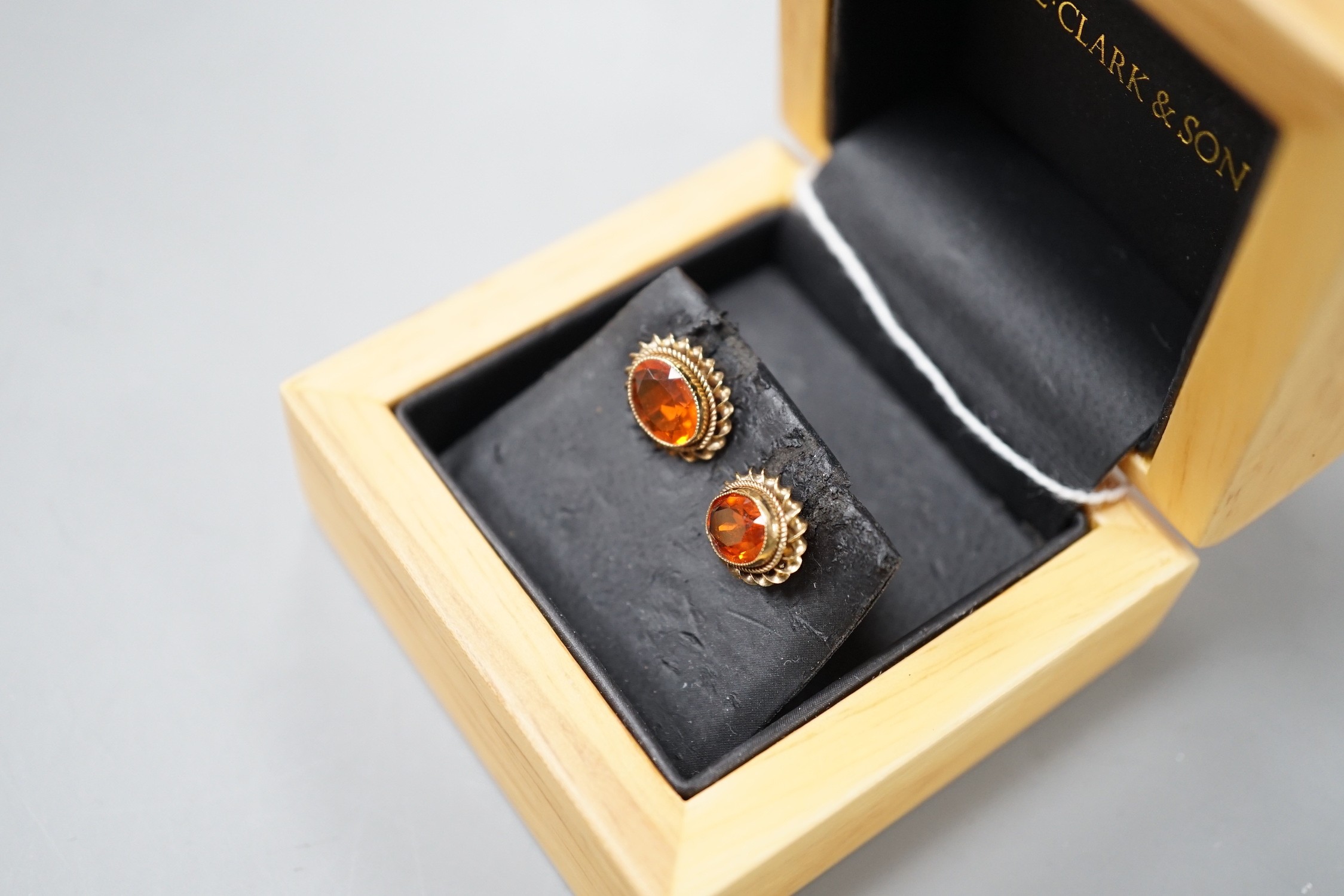 A modern pair of 9ct gold and fire opal set oval earrings, 11mm, gross weight 1.8 grams.